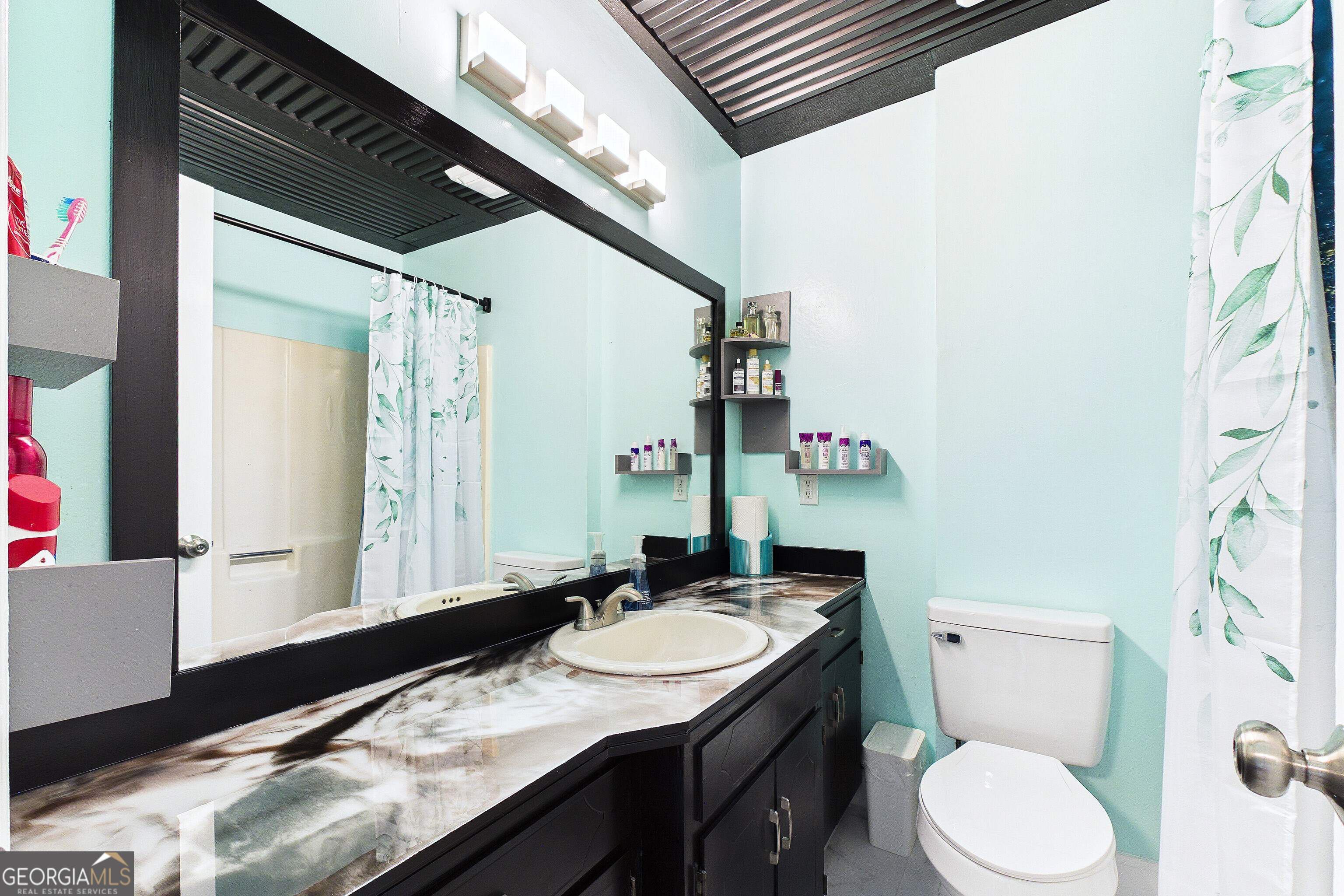 285 Edgewater Drive Macon, GA 31220 - Photo 42 of 66 a bathroom with a granite countertop sink a mirror and a toilet
