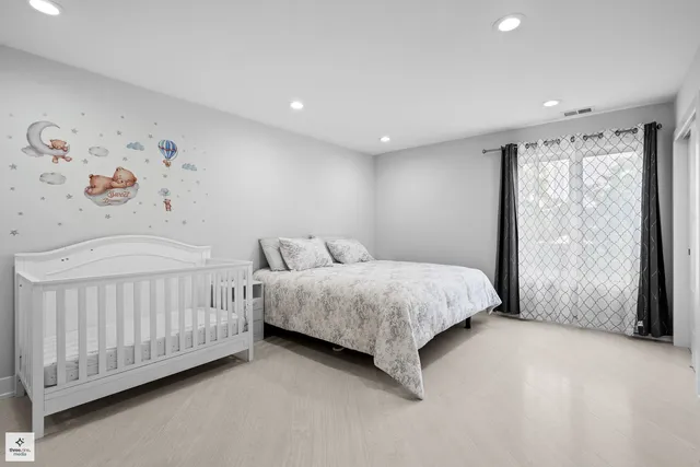 a spacious bedroom with two beds and a window