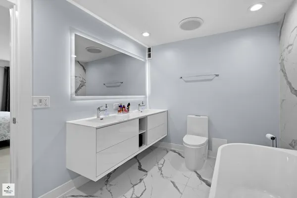 a bathroom with a sink mirror vanity and toilet