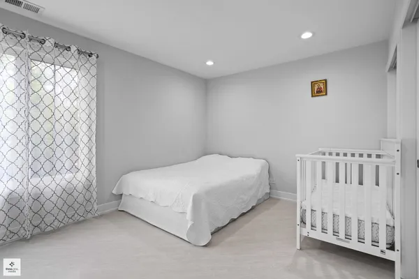 a bed room with a bed and a chair