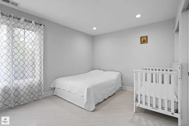 a bed room with a bed and a chair