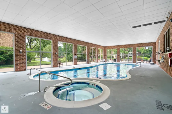 a room with pool table and windows