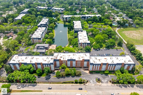 an aerial view of residential houses with outdoor space and swimming pool