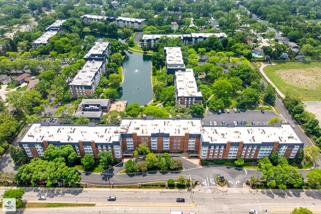 an aerial view of residential houses with outdoor space and swimming pool