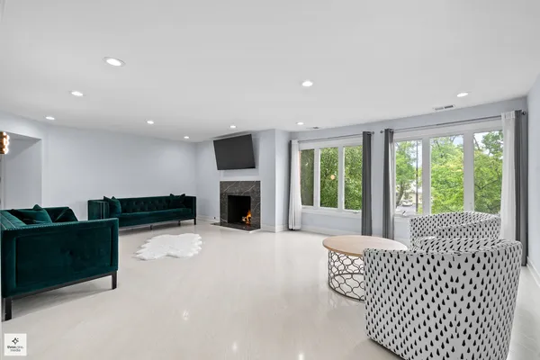 a living room with furniture fireplace and window
