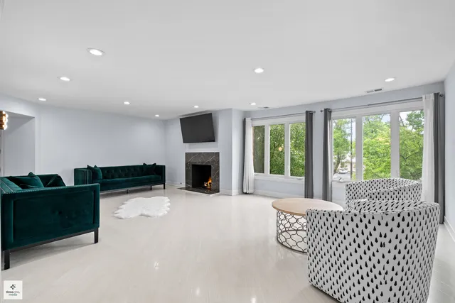 a living room with furniture fireplace and window