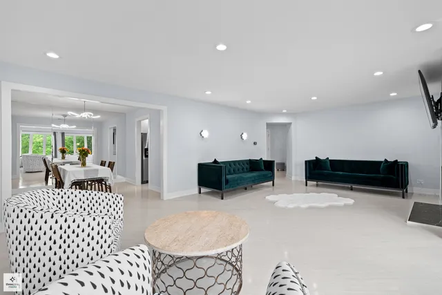 a living room with furniture a rug and white walls