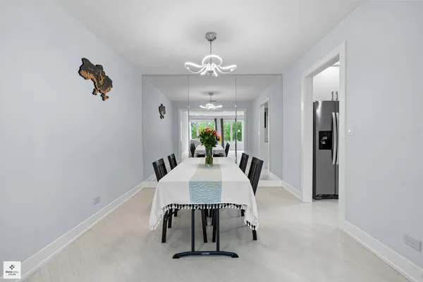 a view of a dining room with furniture and a chandelier