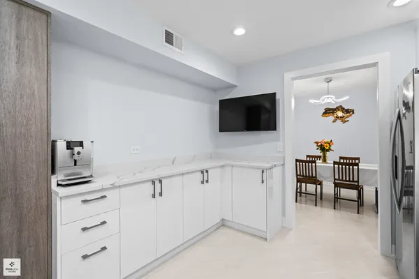 a hallway with cabinets and wooden floor