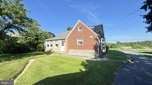 816 North Houcksville Road Hampstead, MD 21074 - Photo 2 of 23 Charming brick home with lush greenery.