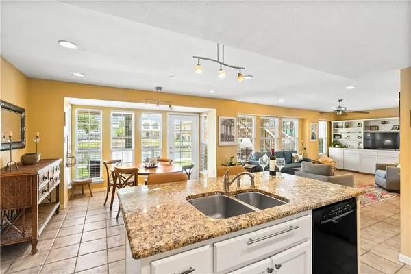 a kitchen with a sink refrigerator and cabinets