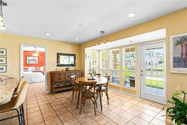 a kitchen with a table chairs refrigerator and microwave