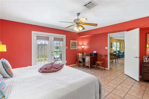 a bathroom with a granite countertop toilet sink and mirror
