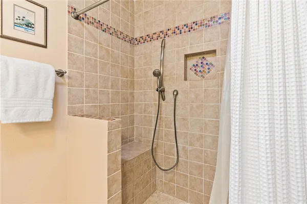 a front view of a house with a yard and potted plants