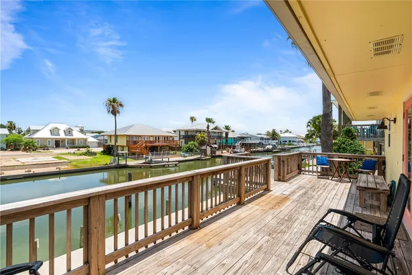 a view of a hallway and workspace with wooden floor and furniture