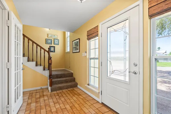 a living room with lots of furniture and kitchen view