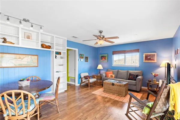 a view of a kitchen with granite countertop a living room dining room and livingroom view