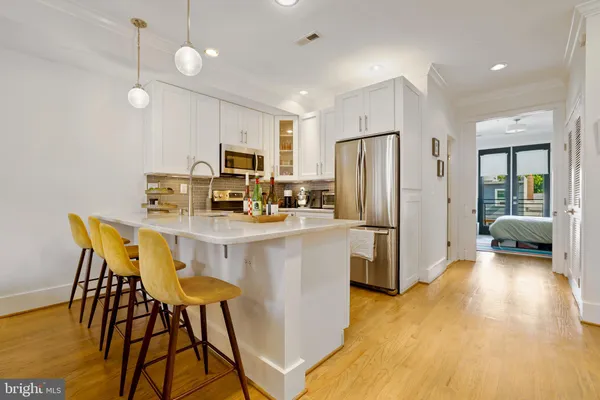 a kitchen with stainless steel appliances a refrigerator and a stove top oven
