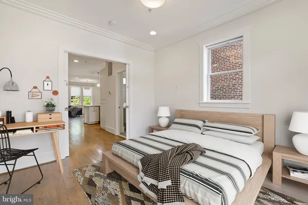 a bedroom with a bed and a table in it