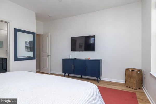 a bedroom with a bed and a flat screen tv