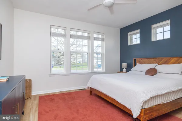 a bedroom with a bed and a large window