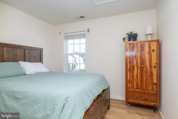 a big room with closet and wooden floor