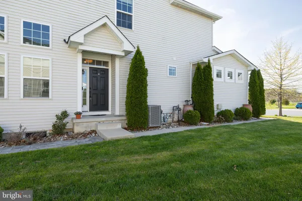 a front view of house with a garden and plants
