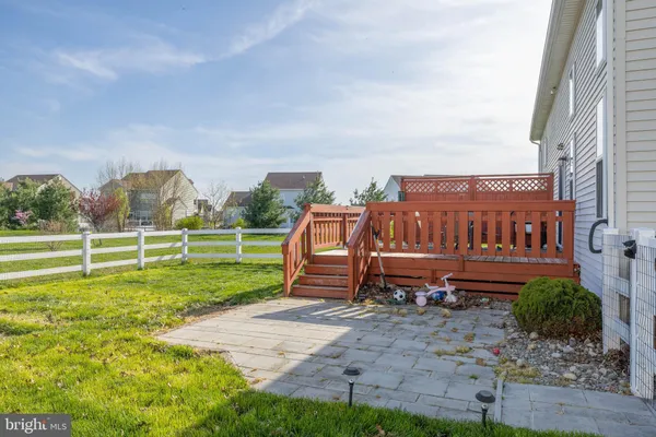 a view of a house with a big yard and large trees