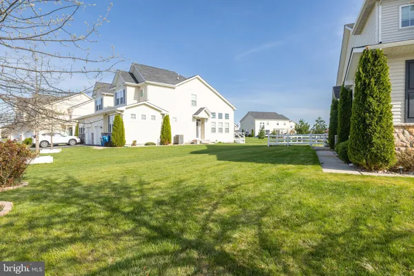 a view of a house with a yard and plants