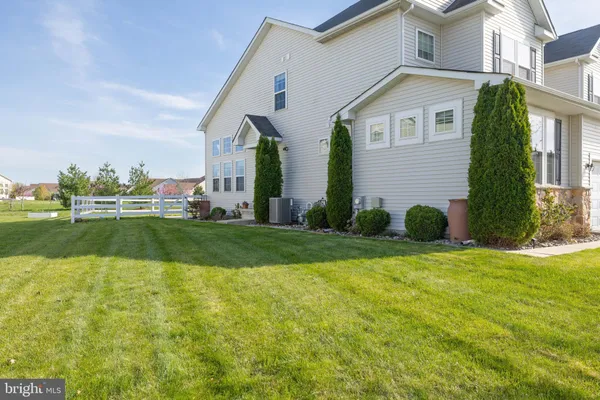 a view of a yard with wooden fence