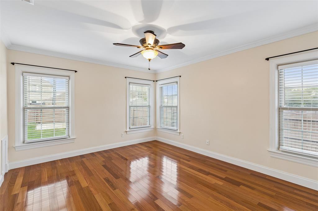 2427 Alco Avenue Dallas, TX 75211 - Photo 16 of 26 a view of an empty room with a window and wooden floor