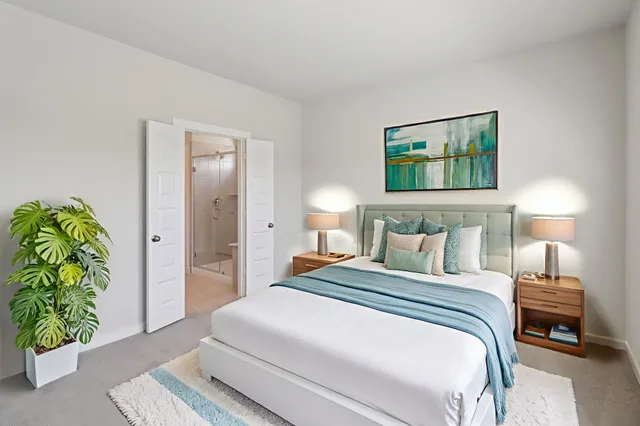 a bedroom with a bed and a painting on the wall