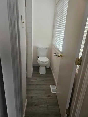 a bathroom with a toilet and a shower