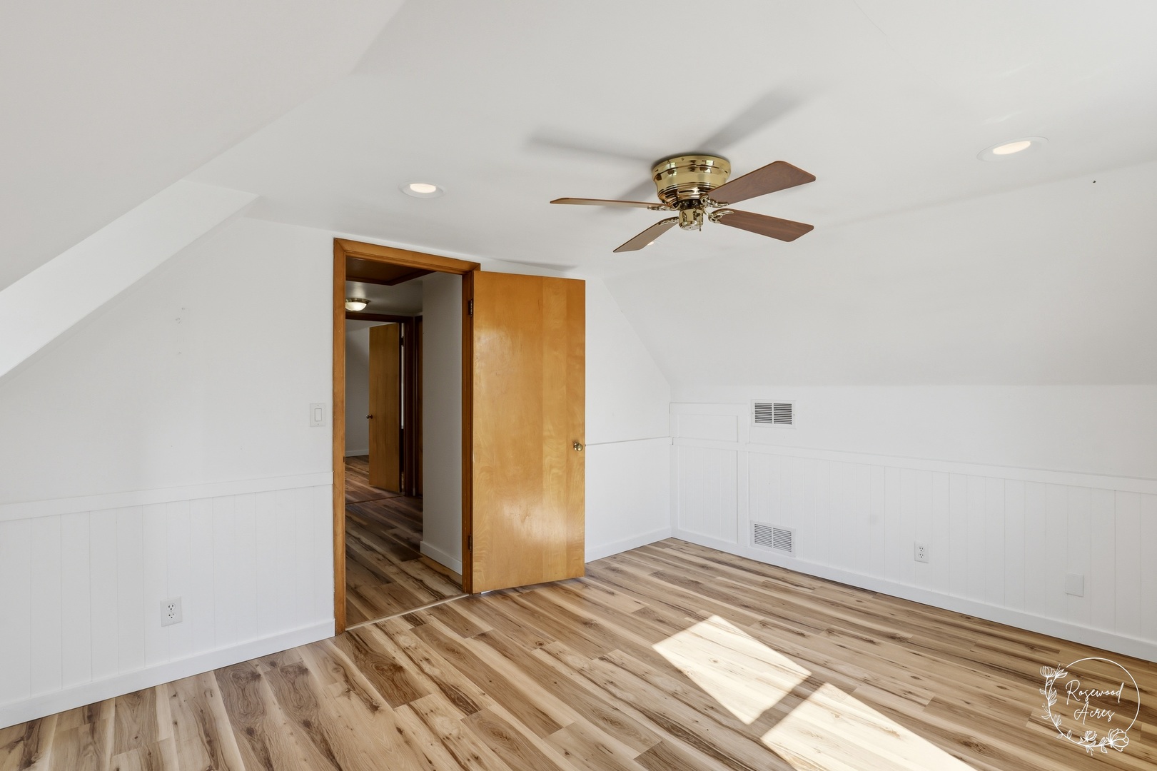1769 West 2000S Road Kankakee, IL 60901 - Photo 23 of 39 a view of a big room with wooden floor and a chandelier fan