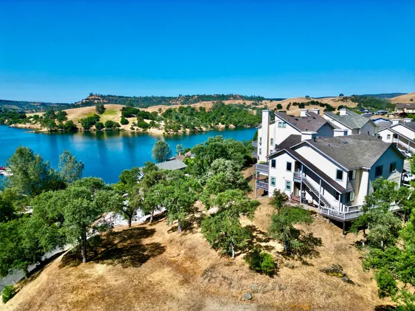 an aerial view of a house with a lake view