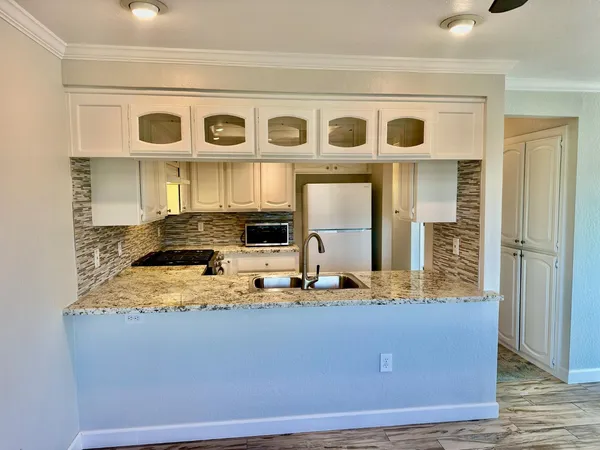 a kitchen with stainless steel appliances granite countertop a stove and a sink