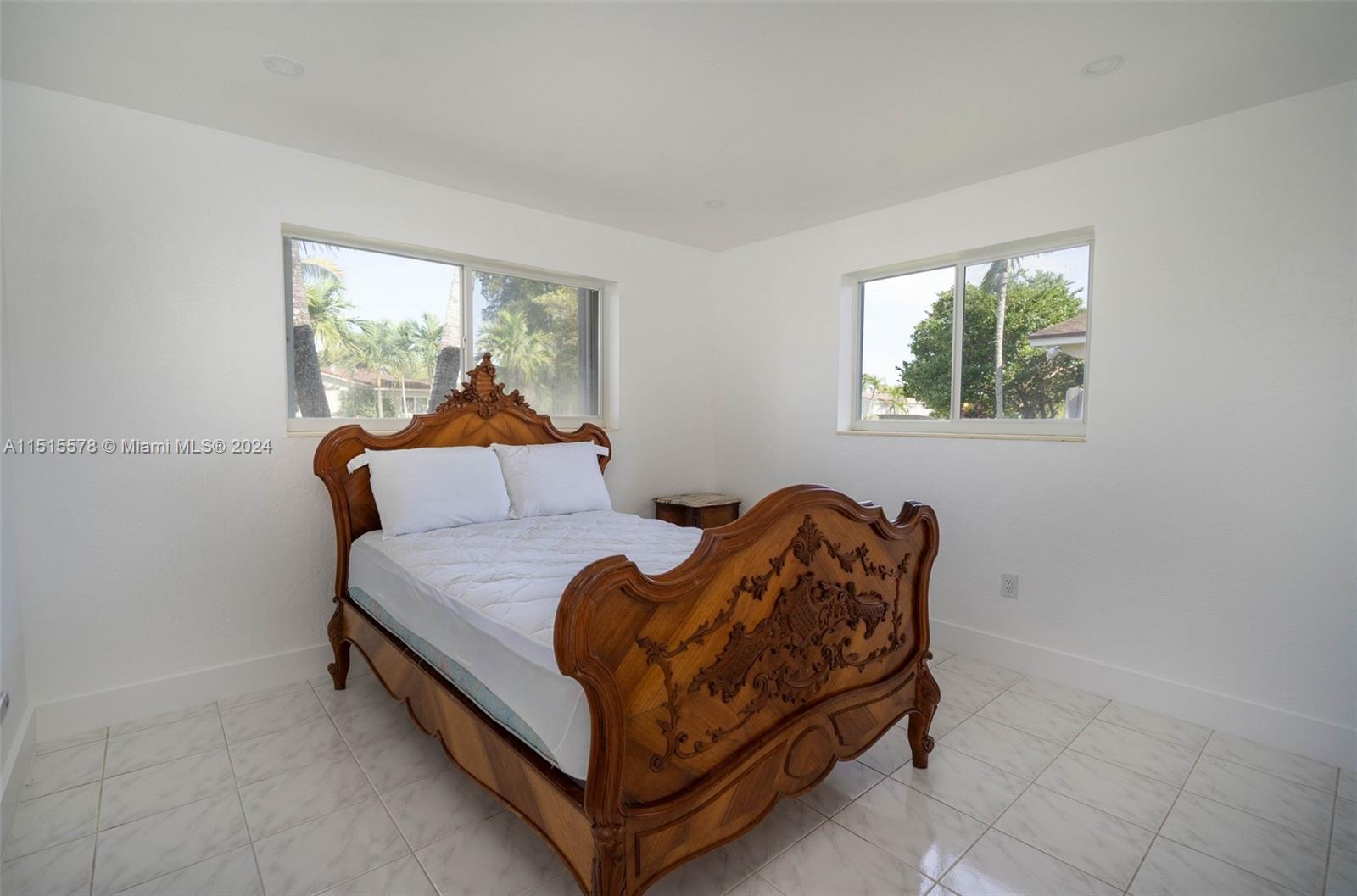 10540 Southwest 98th Street Miami, FL 33176 - Photo 11 of 21 a bed sitting in a bedroom next to a window