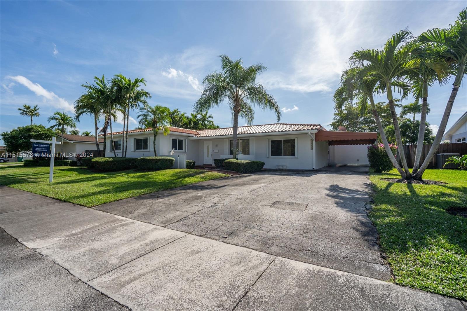 10540 Southwest 98th Street Miami, FL 33176 - Photo 20 of 21 a palm tree sitting in front of a house with a yard