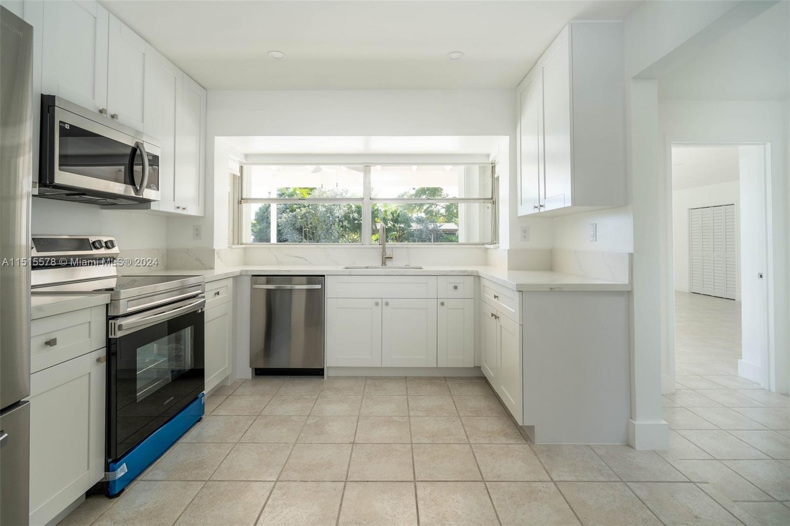 10540 Southwest 98th Street Miami, FL 33176 - Photo 4 of 21 a kitchen with a stove a sink and a microwave