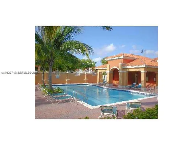 a view of a swimming pool with an outdoor seating