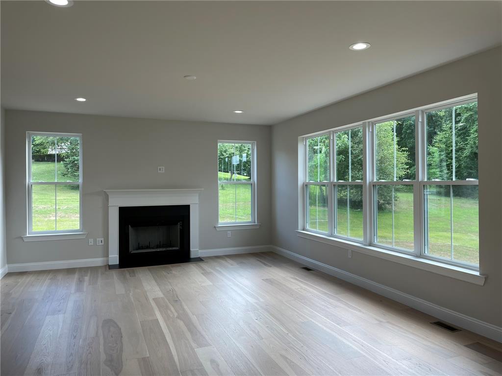 5043 Chapmans Road Orefield, PA 18069 - Photo 30 of 30 Hardwood floors and a welcoming fireplace create a cozy, well-lit gathering space.