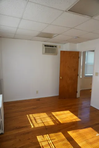 a view of empty room with wooden floor