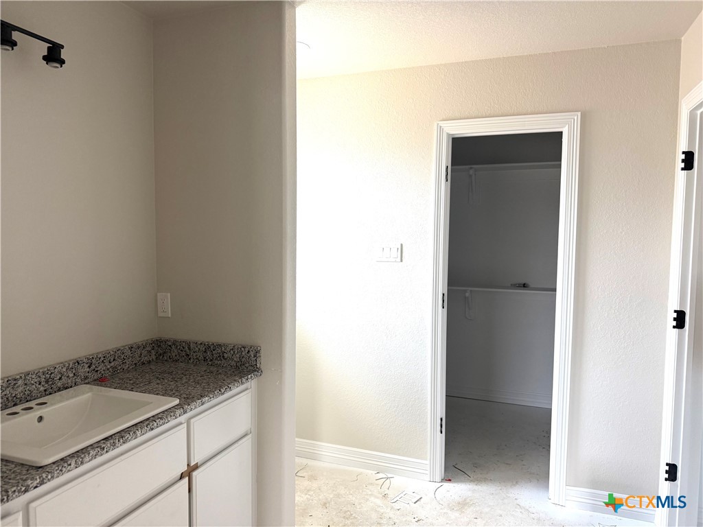3819 Leming Court Temple, TX 76504 - Photo 6 of 9 a bathroom with a granite countertop sink and a mirror