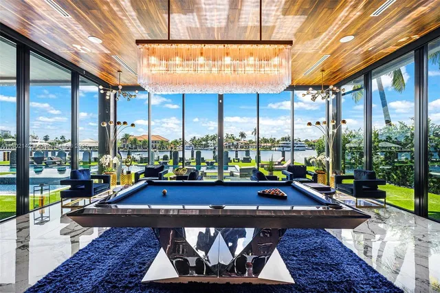 a view of a big yard with swimming pool and lawn chairs