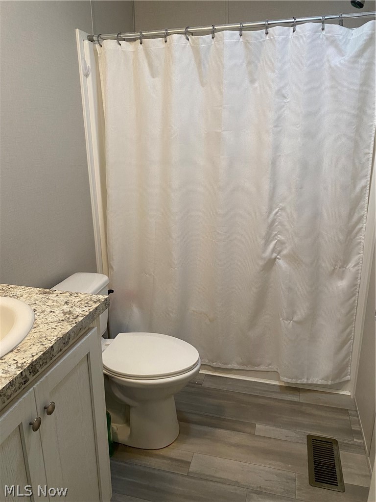 2700 Brookpark Road, Unit 626 Cleveland, OH 44134 - Photo 22 of 32 Bathroom featuring hardwood / wood-style flooring, vanity, and toilet