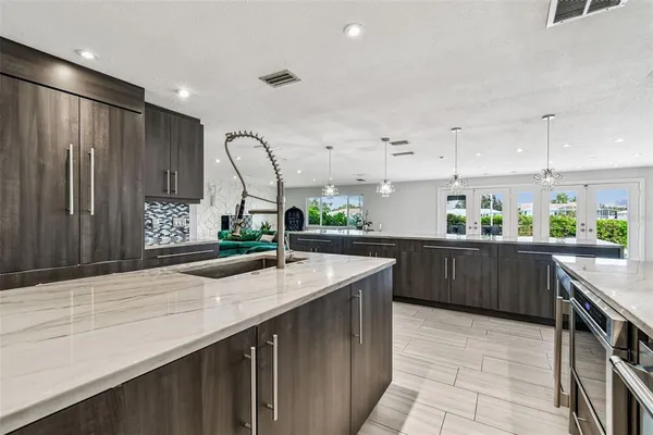 a kitchen with a sink a counter and cabinets