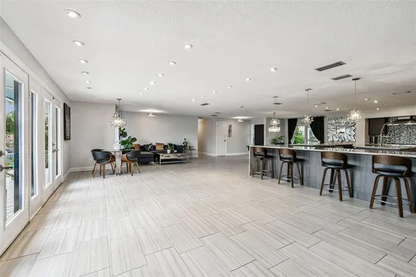 a bedroom with a bed a flat screen tv and a couch