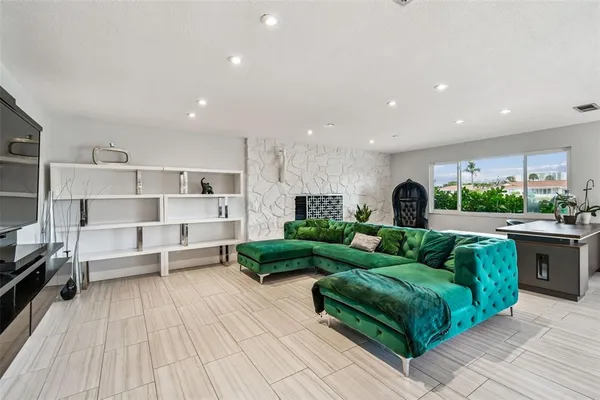 a bed sitting in a bedroom and dressers next to a larger window