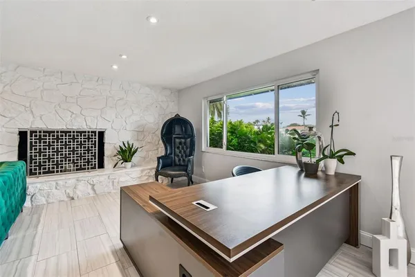 a front view of a house with swimming pool having outdoor seating