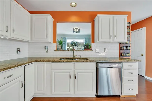 a spacious bedroom with a bed and a chandelier